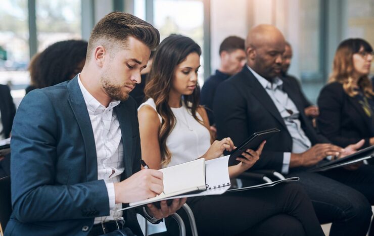 business-people-writing-notes-conference-office-seminar-instruction-learning-corporate-employees-workshop-convention-as-audience-information-knowledge-career_590464-409076